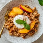 Peach crisp with oat topping and ice cream
