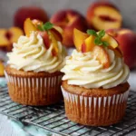 Honey peach cupcakes with cream cheese frosting on a vintage floral plate